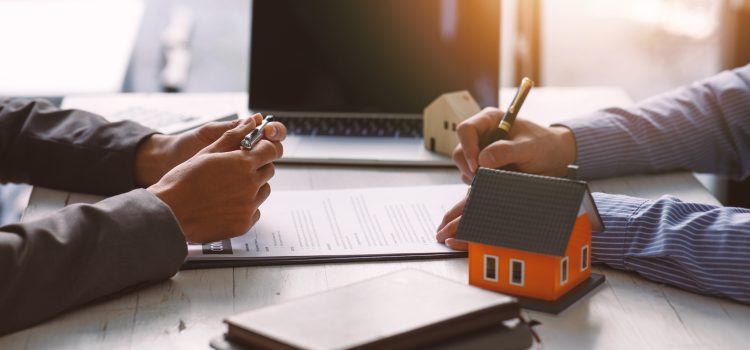 Signing contract agreement after the meeting to state organizations, Business meetings of real estate brokers and company presidents select a home model Construction concept.