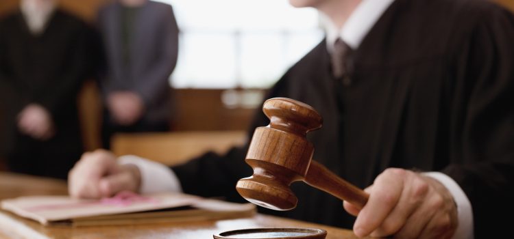 Judge holding gavel in courtroom