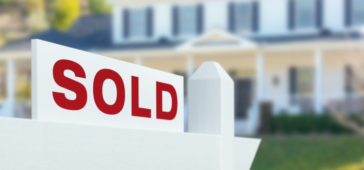 Sold For Sale Real Estate Sign in Front of New House.