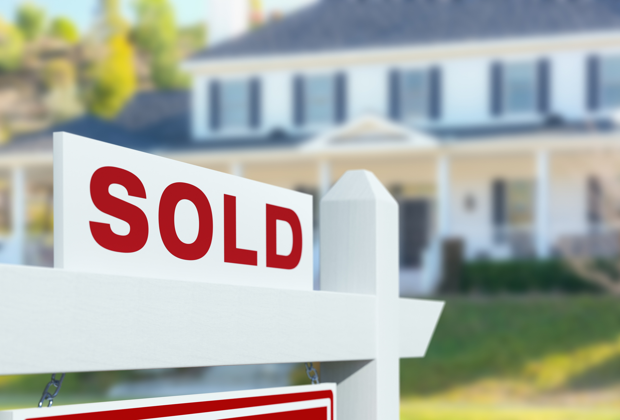 Sold For Sale Real Estate Sign in Front of New House