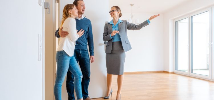 Real Estate Agent showing house to a young couple