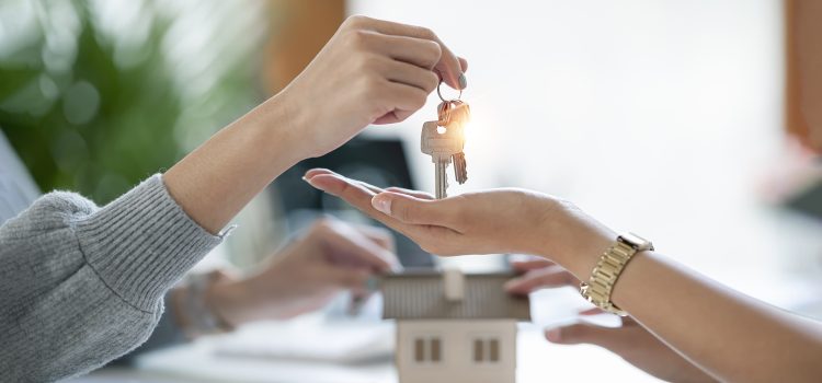 Female realestate agent giving house key to her customer, property, realestate concept.