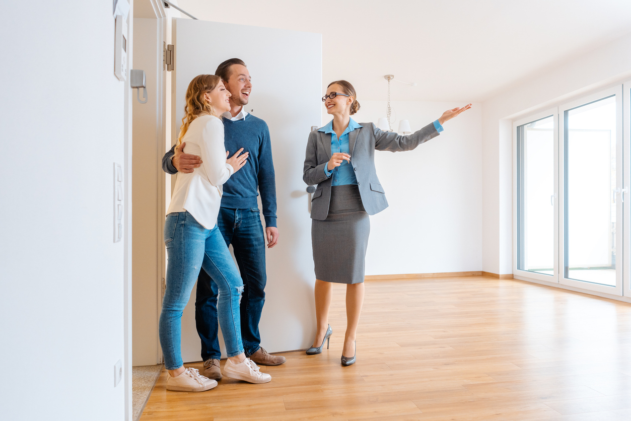 Real Estate Agent showing condo to a young couple
